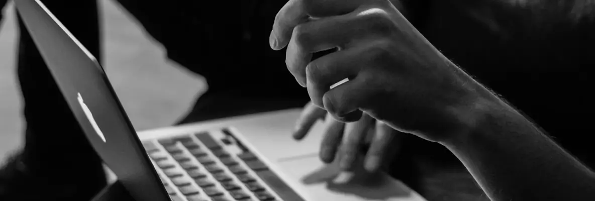 Image of hands writing on a computer